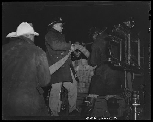 Washington, D.C. Firehouse Station No. 4. Unloading the hose at the scene of a fire