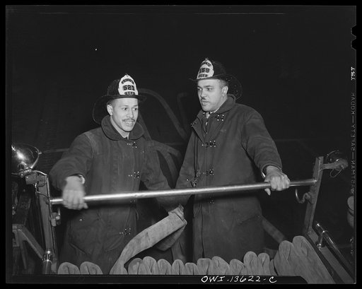 Washington, D.C. Firehouse Station No. 4. Firemen do not wait for the truck to come to a halt when they approach a fire, but jerk the hose into the street and the truck proceeds to the fire. This enables one fireman to hookup the hose to the hydrant while the truck proceeds closer to the fire