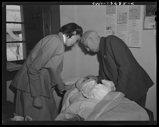 Penasco, New Mexico. Doctor Onstine and a nurse examining a sick baby at the clinic operated by the Taos County cooperative health association