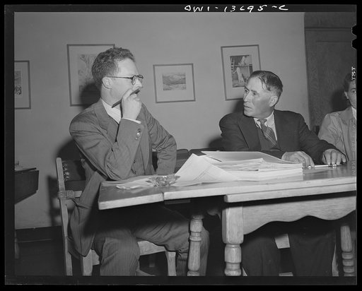 Taos, New Mexico. Jimmy Valentine, Taos County cooperative health association secretary, reasoning a point with a Spanish-American director from Chamisal