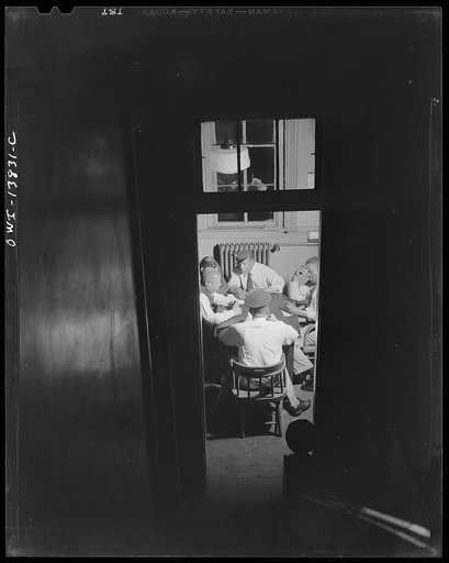 Firehouse Station No. 4. Washington, D.C. Plainclothes detective and fireman playing a game of cards