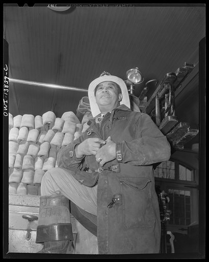 Firehouse Station No. 4. Washington, D.C. Back form the fire Captain Keye takes off his firefighting clothes and platfully kids a young fireman about his first trip to an alarm