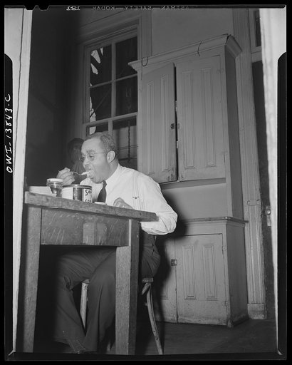 Firehouse Station No. 4. Washington, D.C. Captian Keye taking a bite before going on duty
