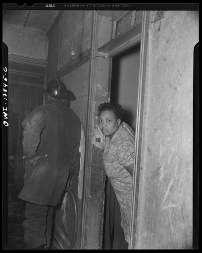 Firehouse Station No. 4. Washington, D.C. A woman looking out her door to see what the excitement is in the next apartment, where a fire was being extinguished by firemen