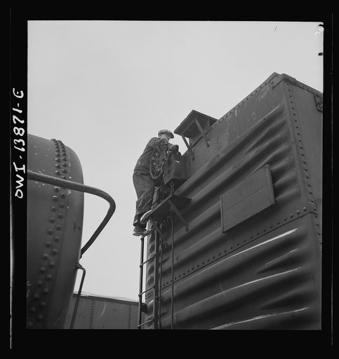 Freight operations on the Indiana Harbor Belt railroad between Chicago, Illinois and Hammond, Indiana. Part of the train inspection consists of releasing the hand brakes