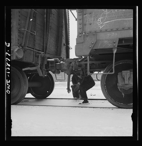 Freight operations on the Indiana Harbor Belt railroad between Chicago, Illinois and Hammond Indiana. Part of the train inspection consists in seeing that all airhose connections are properly made