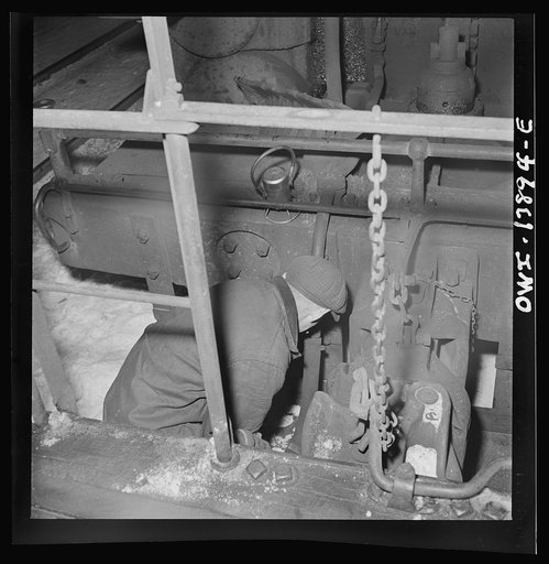 Untitled photo, possibly related to: Freight operations on the Indiana Harbor Belt railroad between Chicago, Illinois and Hammond Indiana. Part of the train inspection consists in seeing that all airhose connections are properly made