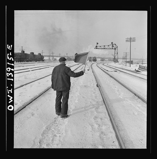 Freight operations on the Indiana Harbor Belt railroad between Chicago, Illinois and Hammond, Indiana. The train stops for a signal and brakeman Zerkel stands beyond it flagging a train coming up from behind