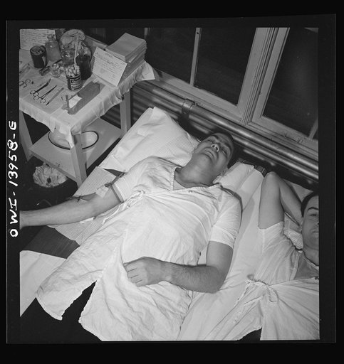 Untitled photo, possibly related to: New York, New York. Italian-American fireman giving pint of blood to the Red Cross