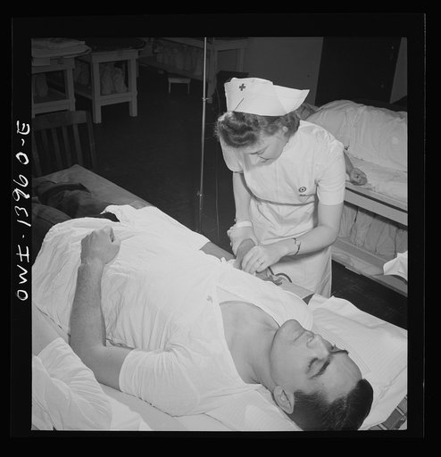 New York, New York. Italian-American fireman giving pint of blood to the Red Cross