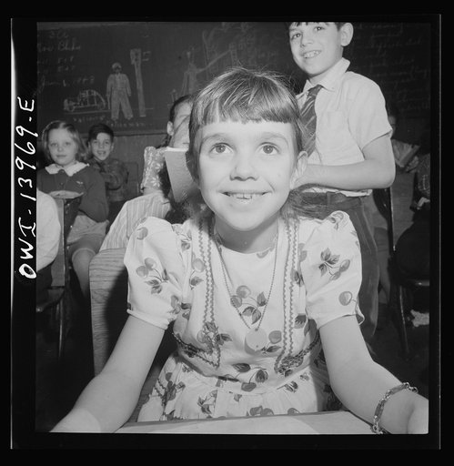 New York, New York. This mother of a child in Public School Eoght is a school defense aid who has volunteered to guard the door of the school, guide visitors, help sell war stamps, etc.