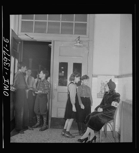 New York, New York. This mother of a child in Public School Eight is a school defense aid who has volunteered to guard the door of the school, guide visitors, help sell war stamps, etc.