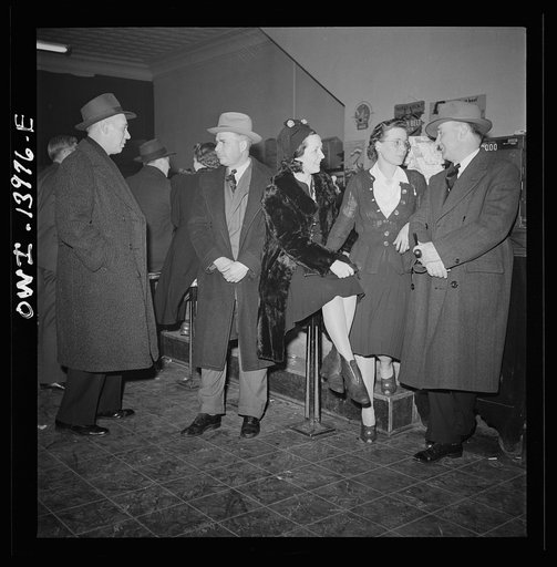 Clinton, Iowa. Rear brakeman Clarence Averill (right) goes over to the bowling alley in the evening with friends. Left to right: Lester Stein, a passenger brakeman on a streamliner; Jim Cross, a freight brakeman; and Miss Lucille Disher, who runs the boarding house where they all stay when in Clinto