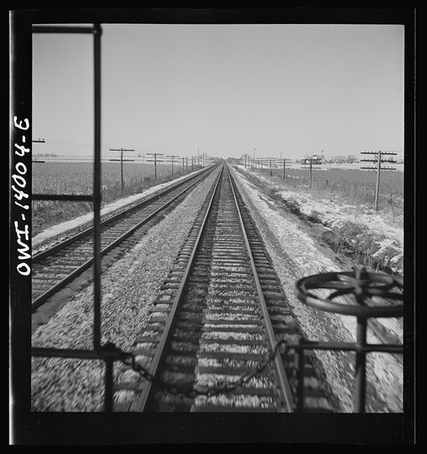 Untitled photo, possibly related to: Freight train operations on the Chicago and Northwestern Railroad between Chicago and Clinton, Iowa. The train rushing through the town of Cortland, Illinois on its way to Iowa