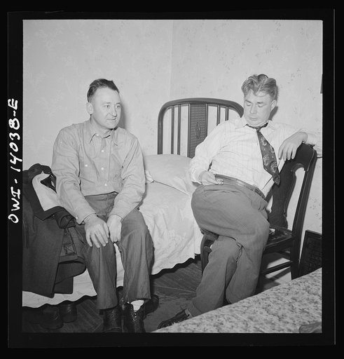 Clinton, Iowa. Jim Cross, brakeman, visiting Clarence Averill, another brakeman on the Chicago and Northwestern Railroad. He has to watch the time because he goes to work at midnight