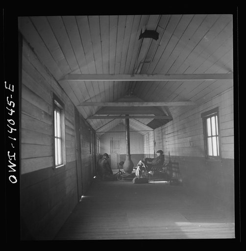 Untitled photo, possibly related to: Freight train operations on the Chicago and Northwestern Railroad between Chicago and Clinton, Iowa. At the end of the trip, Conductor Wolfsmith waits at the little railroad station for a suburban train to take him back home to Chicago. A welder, who works at the