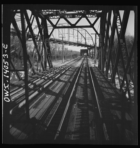 Untitled photo, possibly related to: Freight train operations on the Chicago and Northwestern Railroad between Chicago and Clinton, Iowa. The train crosses a long steel bridge