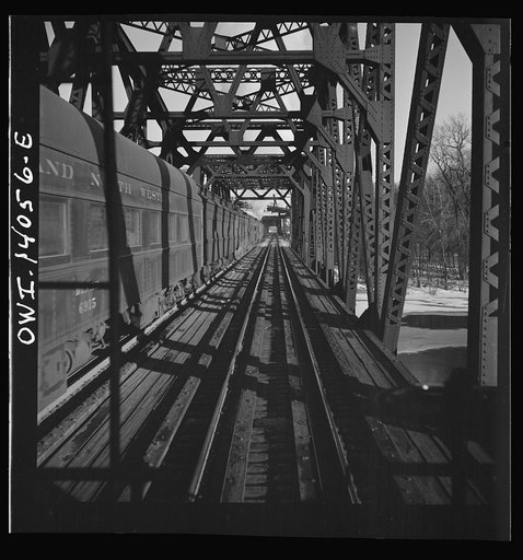 Freight train operations on the Chicago and Northwestern Railroad between Chicago and Clinton, Iowa. The train crosses a long steel bridge