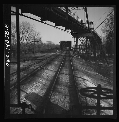Untitled photo, possibly related to: Freight train operations on the Chicago and Northwestern Railroad between Chicago and Clinton, Iowa. The train crosses a long steel bridge
