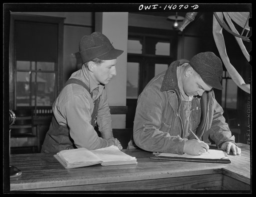 Gibson, Indiana. L.R. Pierce (right) and R.E. Ewing registering at the railroad YMCA (Young Men's Chirstian Association). Both are brakemen on the New York Central railroad