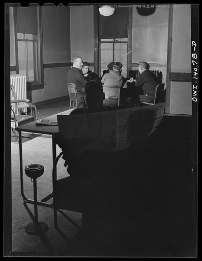 Untitled photo, possibly related to: Gibson, Indiana. A card game is nearly always in progress in the lobby of the railroad YMCA (Young Men's Christian Association)