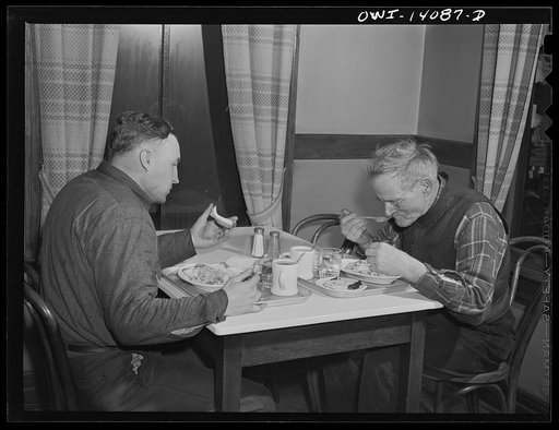 Gibson, Indiana. Lester Gale (left), signal maintainer on the Indiana Harbor Belt railroad, and Charles Cornetta, railroad mail clerk, having dinner in the cafeteria of the railroad YMCA (Young Men's Christian Association)