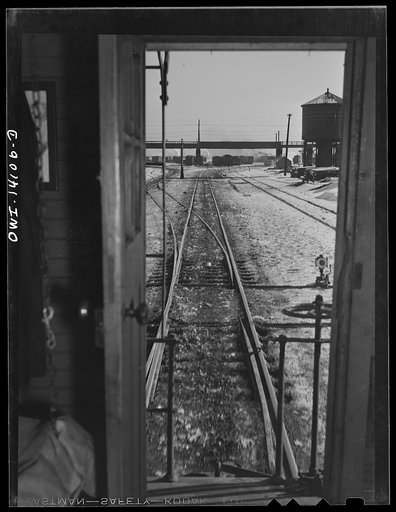 Untitled photo, possibly related to: Freight train operations on the Chicago and Northwestern Railroad between Chicago and Clinton, Iowa. The train rushing through the town of Malta, Illinois on its way to Clinton
