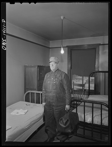 Mr. E. S. Devine, fireman on the Indiana Harbor Belt and Michigan Central Railroads in his room at the railroad YMCA (Young Men's Christian Association)