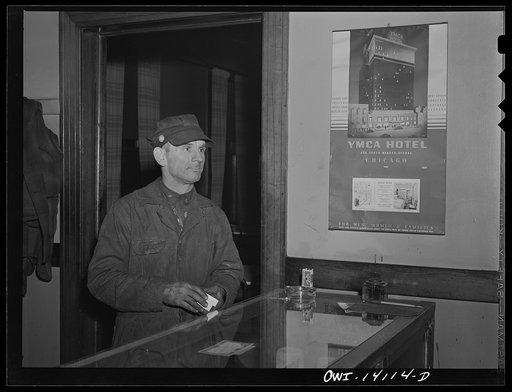 Gibson, Indiana. A railroad worker buying some cigarettes at the desk in the railroad YMCA (Young Men's Christian Association)