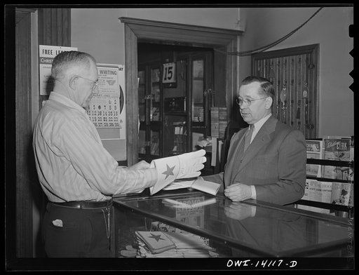 Gibson, Indiana. Mr. H. O. Wright, engineer on the New York Central and the Indiana Harbor Belt Railroad buying a new pair of gloves at the railroad YMCA (Young Men's Christian Association)