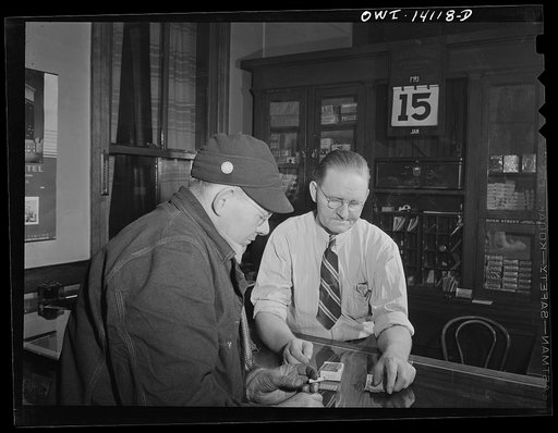 Gibson, Indiana. A railroad worker buying some cigarettes at the railroad YMCA (Young Men's Christian Association)