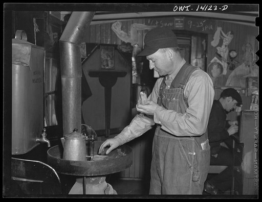 Mr. Averill, rear brakeman, having his lunch in the caboose of an eastbound Chicago and Northwestern Railroad freight train heading for Chicago