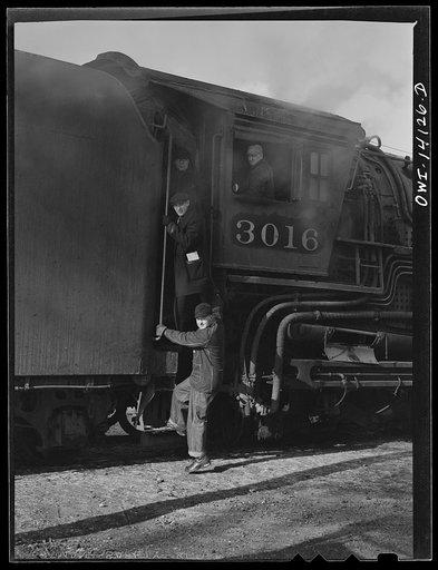 On arriving at the yard, the Chicago and Northwestern Railroad freight train is left in the receiving yard and the engine is taken to the roundhouse. On its way over there, they stop to let the conductor and brakeman off to go home