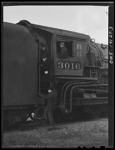 Untitled photo, possibly related to: On arriving at the yard, the Chicago and Northwestern Railroad freight train is left in the receiving yard and the engine is taken to the roundhouse. On its way over there, they stop to let the conductor and brakeman off to go home