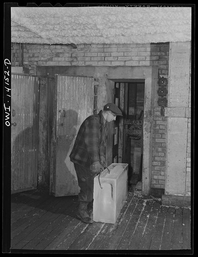 Block of ice being sent up an elevator into the storehouse of the Indiana Harbor Belt Railroad