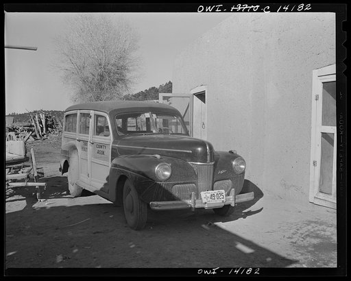 Penasco, New Mexico. Ambulance of the clinic operated by the Taos County cooperative health association in front of a Spanish-American home to rush an obstetrical case to the hospital
