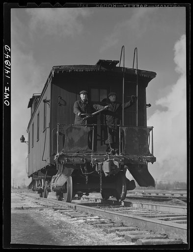 A caboose rolling down the hump to join its train in a classification yard of the Indiana Harbor Belt Railroad