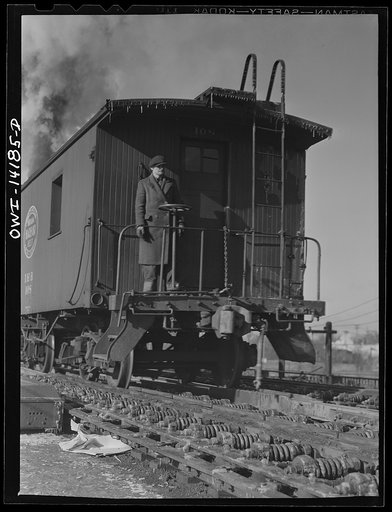 Untitled photo, possibly related to: A caboose rolling down the hump to join its train in a classification yard of the Indiana Harbor Belt Railroad