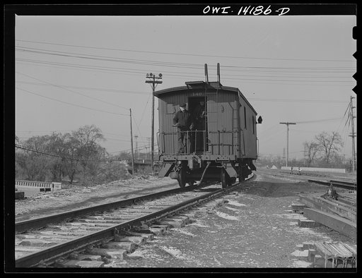 A caboose rolling down the hump to join its train in a classification yard of the Indiana Harbor Belt Railroad