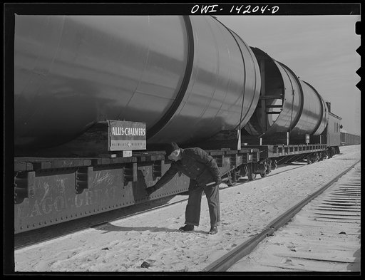 Chicago, Illinois. Rear brakeman checking air in each car as part of his inspections before a Chicago and Northwestern Railroad train pulls out