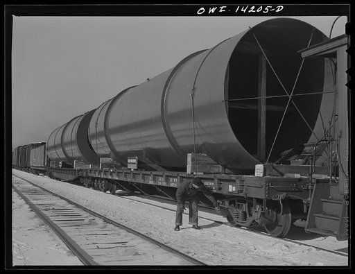 Chicago, Illinois. Rear brakeman checking air in each car as part of his inspections before a Chicago and Northwestern Railroad train pulls out