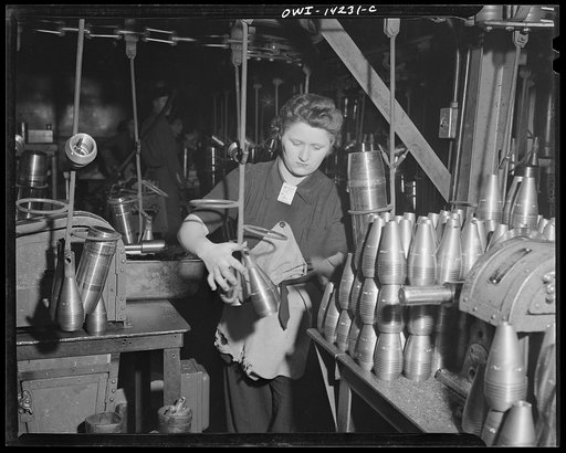 Detroit, Michigan. Steps in the manufacture of casings for 105 mm. shells in the Budd wheel plant. Stamping a 60 mm. shell