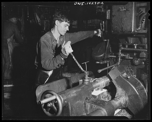 Detroit, Michigan. Steps in the manufacture of casings for 105 mm. shells in the Budd wheel plant. Finishing the forward end of a shell