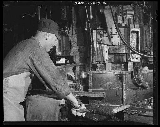 Detroit, Michigan. Steps in the manufacture of casings for 105 mm. shells in the Budd wheel plant. Finishing the base end of a shell