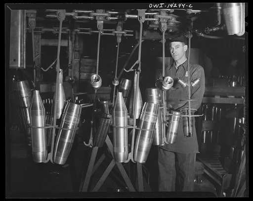 Detroit, Michigan. Steps in the manufacture of casings for 105 mm. shells in the Budd wheel plant. Conveyor to the painting and packing department
