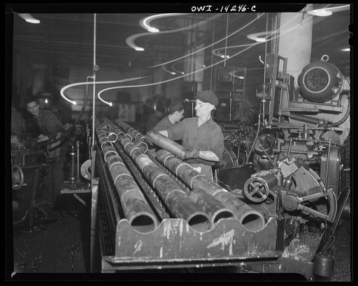 Detroit, Michigan. Steps in the manufacture of casings for 105 mm. shells in the Budd wheel plant. Rough machine conveyor