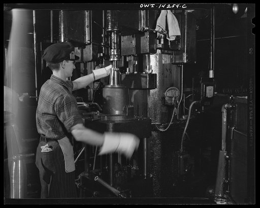 Detroit, Michigan. Steps in the manufacture of casings for 105 mm. shells in the Budd wheel plant. Counter boring the interior of the cavity of a shell