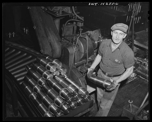 Detroit, Michigan. Steps in the manufacture of casings for 105 mm. shells in the Budd wheel plant. Machining the rotating band