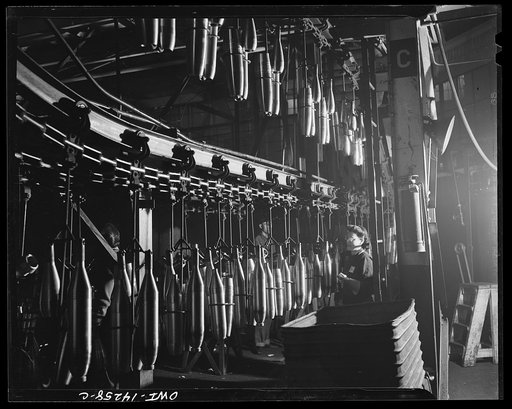 Detroit, Michigan. Steps in the manufacture of casings for 105 mm. shells in the Budd wheel plant. Convyeor to the painting and packing department