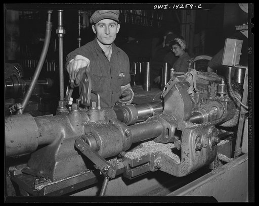 Detroit, Michigan. Steps in the manufacture of casings for 105 mm. shells in the Budd wheel plant. Machining the rotating band on the shell